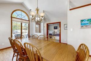 a dining room with a wooden table and chairs at Sunny Day in Ocean City +25 photos