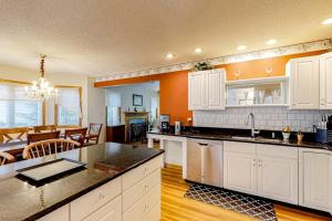 a kitchen with white cabinets and a dining room at Ocean Pines Fairway in Ocean Pines
