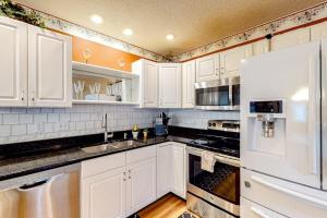 a kitchen with white cabinets and a white refrigerator at Ocean Pines Fairway in Ocean Pines +26 photos