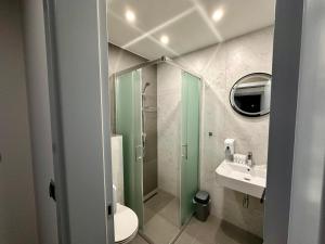 a bathroom with a shower and a toilet and a sink at Prenoćište Vozač in Jajce