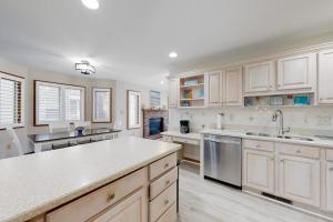 a kitchen with white cabinets and white counter tops at Trinity Place Treasure in Ocean Pines +15 photos