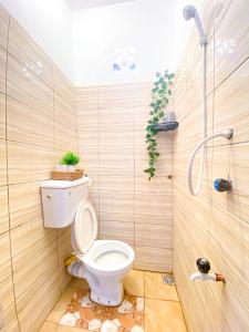 a bathroom with a toilet and a shower at KL beach road Diani in Ukunda +2 photos
