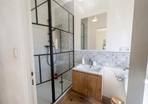 a bathroom with a shower and a sink and a mirror at L'Opale in Roanne +4 photos