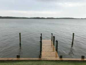 a wooden dock in the middle of a lake at 14 Clipper on the Bay in Ocean Pines