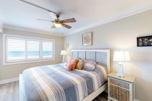 a bedroom with a bed and a ceiling fan at Plaza 211 in Ocean City
