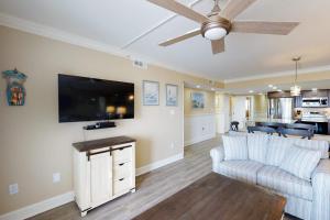 a living room with a couch and a flat screen tv at Plaza 211 in Ocean City