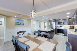 a kitchen with a table and chairs and a dining room at Plaza 211 in Ocean City +13 photos