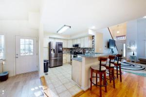 a kitchen with a counter and bar stools in it at 5 Whitecap in Ocean Pines +41 photos
