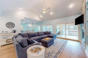a living room with a couch and a tv at Turtle Shores in Ocean Pines