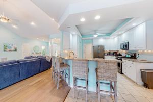 a kitchen and living room with a couch and a bar at Turtle Shores in Ocean Pines +52 photos