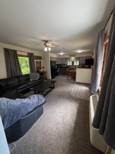 a living room with a couch and a table at Maple Ridge Trail Side Cabin in Crandon