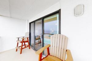 a room with two rocking chairs and a window at Summer Beach 602 in Ocean City