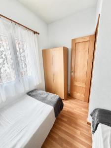 a bedroom with a bed and a wooden cabinet at Villa Banfield in Gran Alacant +35 photos