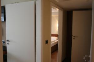 a bedroom with a bed and a door at Dürer-Hotel in Nuremberg