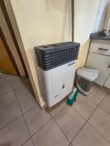 a bathroom with a heater next to a toilet at Cabaña 6D in Concordia