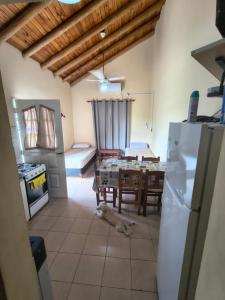a kitchen and dining room with a dog laying on the floor at Cabaña 6D in Concordia