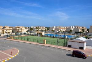 a tennis court on the side of a street at Villa Banfield in Gran Alacant