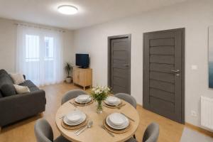 a living room with a table and a couch at Apartament Fabryczna TK in Namysłów