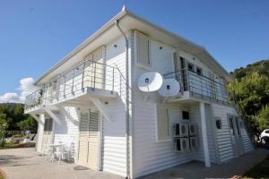 a white building with a balcony on the side of it at Shengjin villa in Shëngjin