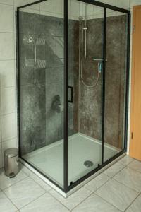 a shower with a glass door in a bathroom at Narnia in Heede +9 photos