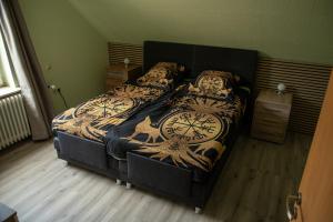 a bedroom with a bed with a clock on it at Narnia in Heede
