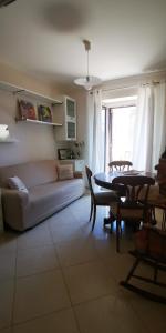 a living room with a couch and a table at Donna Rosa - Main Avenue in Taormina