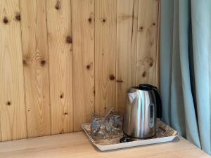 a coffee pot and glasses on a tray on a table at Magdelena in Palanga