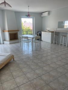 a kitchen and dining room with a table and chairs at RRooms in Nafpaktos +11 photos