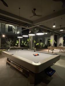 a pool table in the middle of a room at Grids by Epic Collection in Unawatuna
