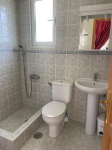 a bathroom with a toilet and a sink at RRooms in Nafpaktos
