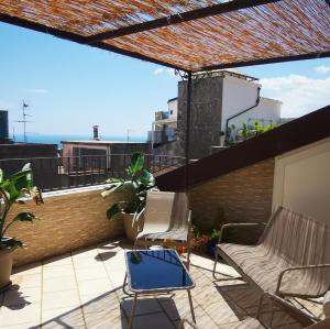 a patio with two chairs on a roof at Donna Rosa - Main Avenue in Taormina
