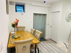 a dining room with a wooden table and chairs at Ideal Guest House in Carrick-on-Suir