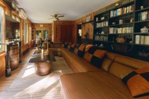 a living room with a couch and book shelves at The Luxury Cabin at Deep Hollow in Narrowsburg