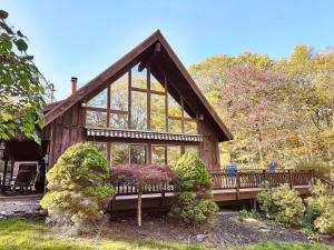 a wooden cabin with a large window at The Luxury Cabin at Deep Hollow in Narrowsburg