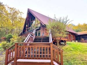 a large wooden house with a large wooden deck at The Luxury Cabin at Deep Hollow in Narrowsburg +80 photos