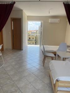 a room with beds and a view of a balcony at RRooms in Nafpaktos