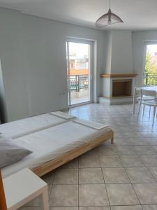 a bedroom with a bed and a table and chairs at RRooms in Nafpaktos