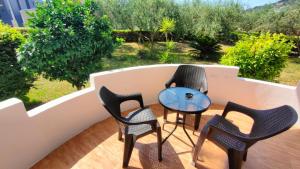 a group of chairs and a table on a balcony at Casa Lu in Ulcinj +6 photos