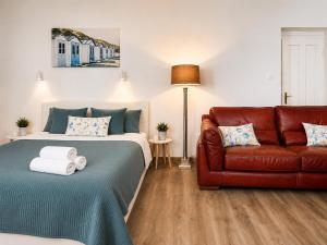 a bedroom with a bed and a couch at Esther's Studio Keszthely in Keszthely