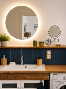 a bathroom with a sink and a mirror at Esther's Studio Keszthely in Keszthely +12 photos