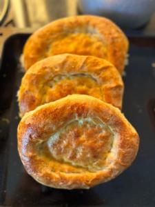 a group of three pastries sitting on a pan at Ak-Bulak in Kurmenty