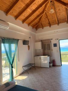 a large room with a kitchen and a living room at Sunset elafonisos in Elafonisos