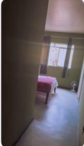 a room with a bench and a window in a room at hotel larena in Sete Lagoas
