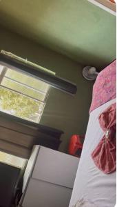 a small bedroom with a bed and a window at hotel larena in Sete Lagoas