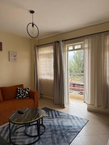 a living room with a couch and a glass table at Luxe homes kenol in Kabuku