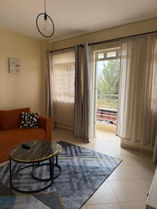 a living room with a couch and a table at Luxe homes kenol in Kabuku