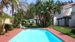 a swimming pool in the backyard of a house at Innisfree Apartments in Gaborone