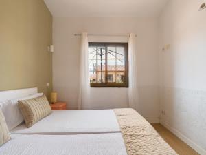 a white bedroom with a bed and a window at Sunny Haven I in Maspalomas +38 photos