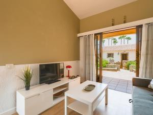 a living room with a tv and a couch at Sunny Haven I in Maspalomas