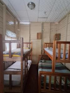 a small room with two bunk beds in it at Hostal South beach in Carenero